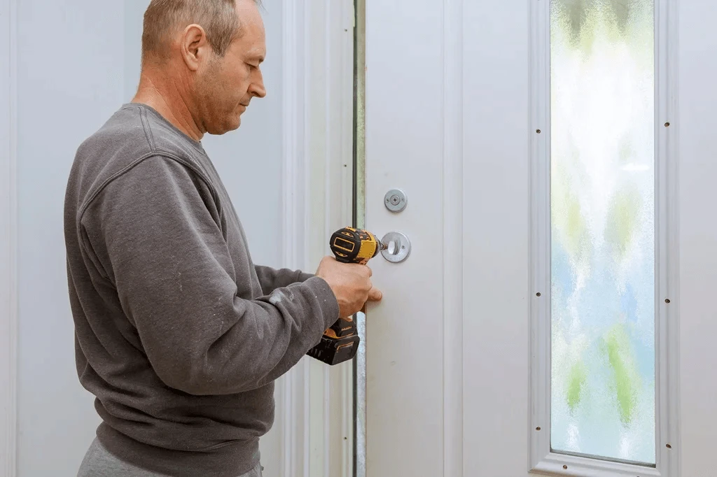 worker installing steel doors for a house