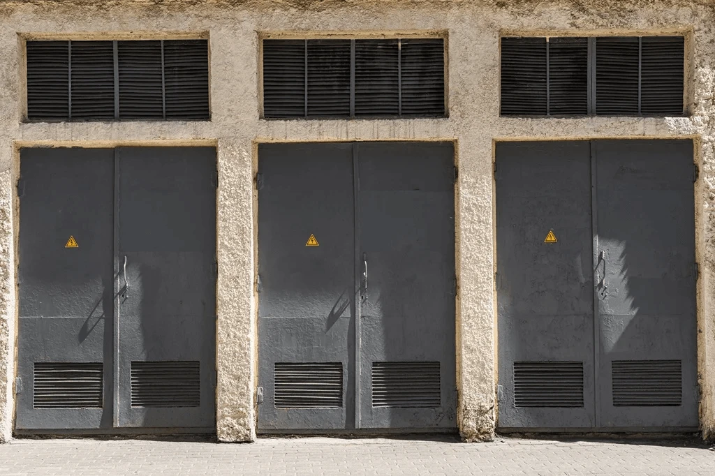 industrial doors with electric warning signs for a manufacturing facility