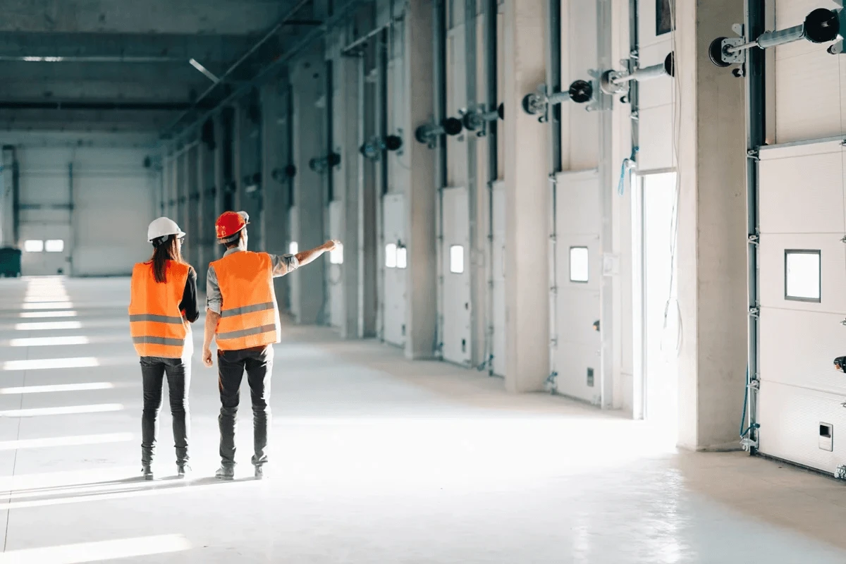 industrial workers inspecting the doors in the facility