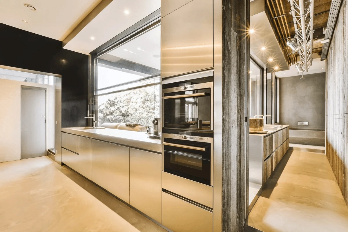 spacious living room with an open kitchen featuring stainless steel