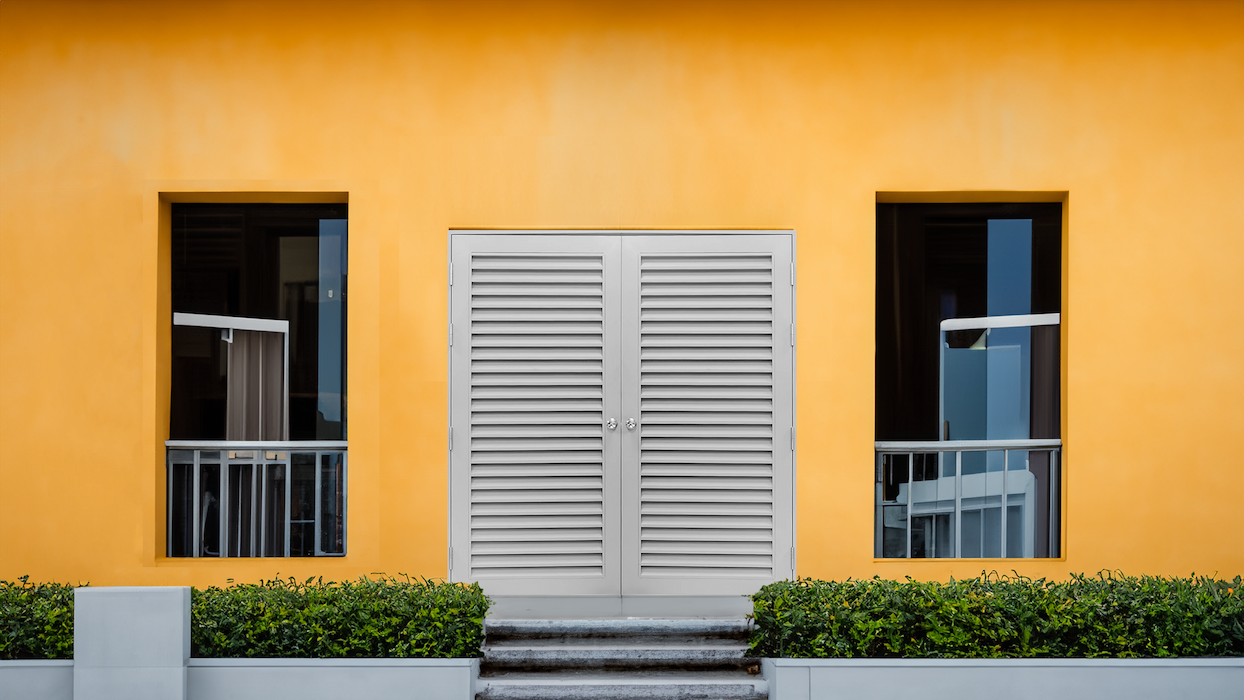 double leaf louvered steel door installed in building